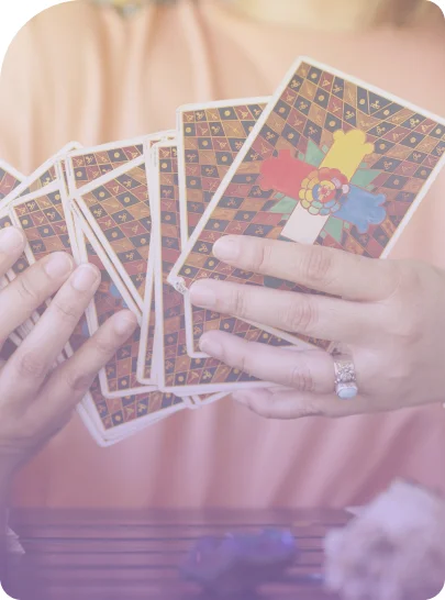 A zoom picture of Mariel's hands shuffling tarot cards